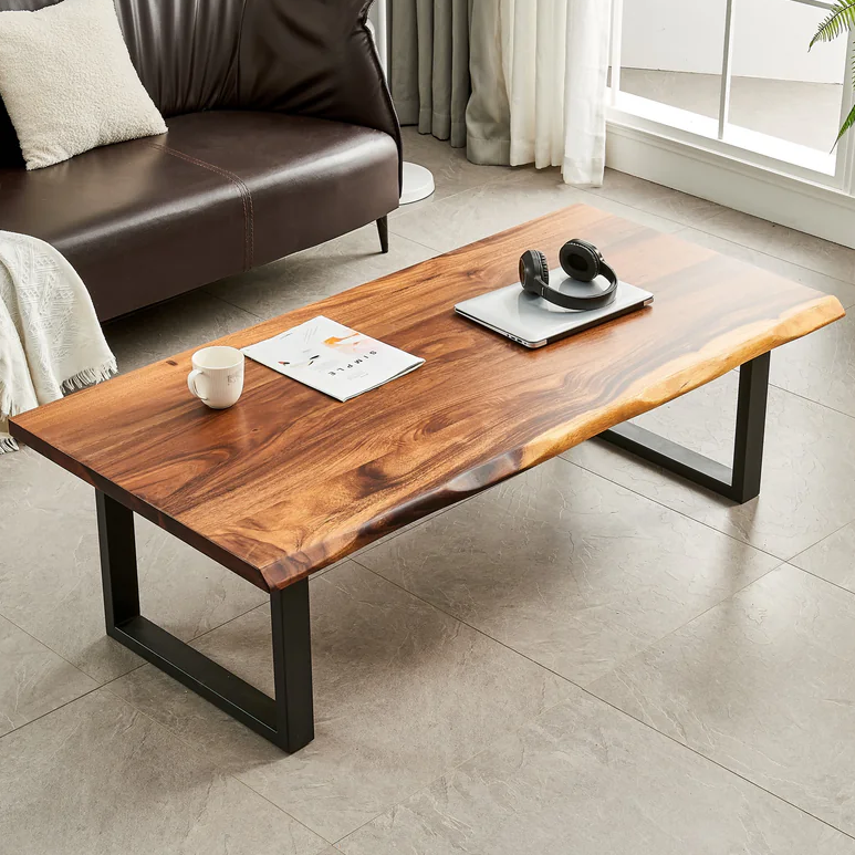Live Edge Coffee Table with walnut top and black U-shaped legs by a brown leather sofa