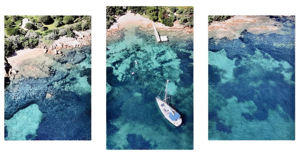 3-Panel Canvas Wall Art Ocean showing an aerial view of a sailboat in turquoise water near a green shore