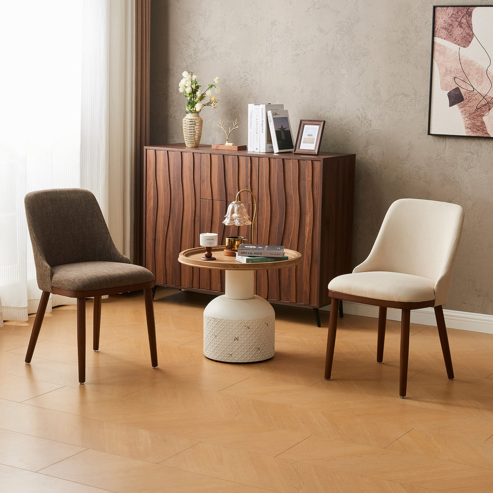 Modern Upholstered Dining Chairs in beige and cream flanking a side table by a wood credenza