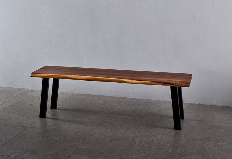 Angled view of Live Edge Dining Bench showing walnut grain and live edge with black legs