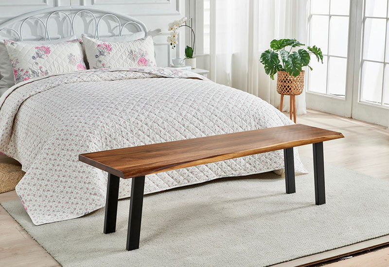 Live Edge Dining Bench used as seating at the foot of a bed in a bright bedroom
