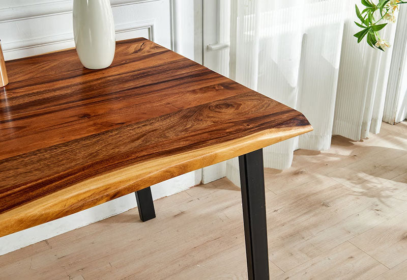 Close-up corner of Live Edge Dining Table showing walnut grain and live edge with black tapered leg
