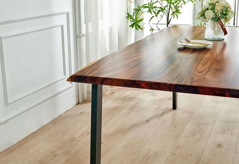 Live Edge Dining Table with dark walnut top styled with place setting and flowers by a sunny window