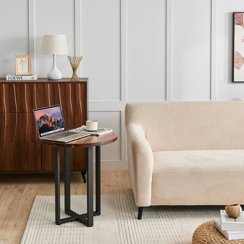 Round End Table in walnut used as a laptop table beside a sofa and wood credenza