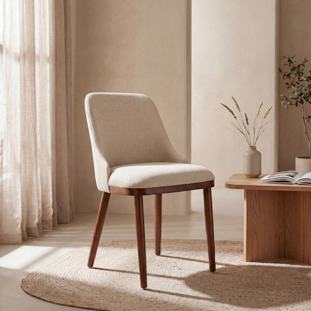 Modern Upholstered Dining Chair in cream fabric in a sunlit minimalist room with a jute rug