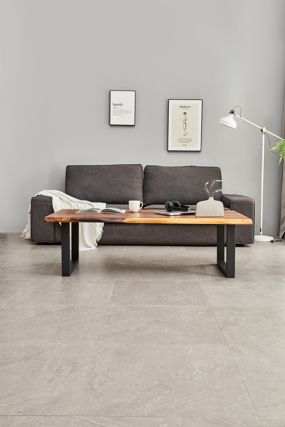 Live Edge Coffee Table with walnut top and black legs in front of a gray sofa