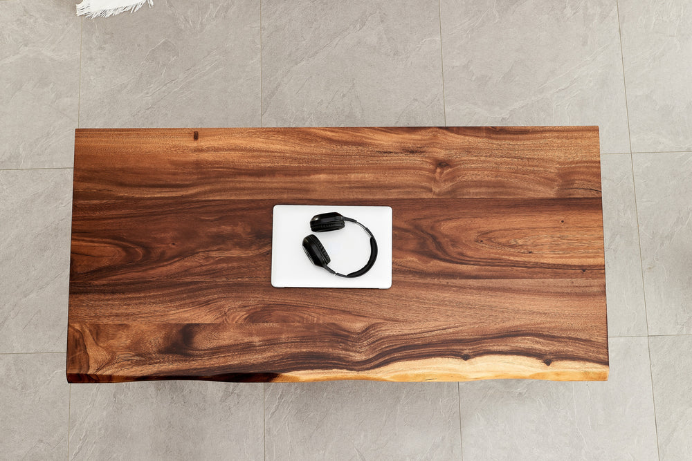 Overhead view of Live Edge Coffee Table walnut grain with laptop and headphones
