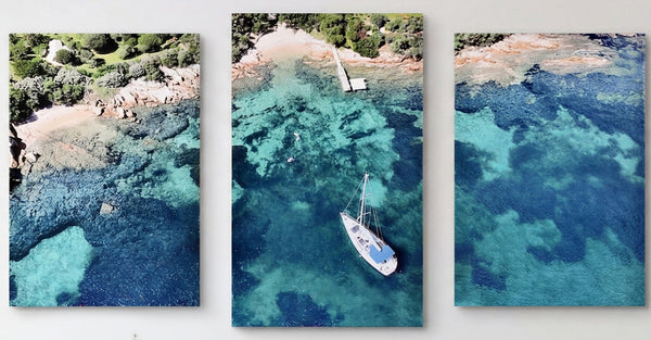 3-Panel Canvas Wall Art Ocean showing an aerial view of a sailboat in turquoise water near a green shore