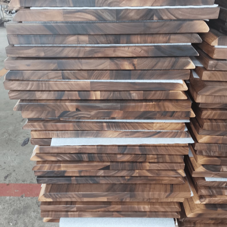 Stacks of finished DIY Live Edge Walnut Table Tops in the workshop
