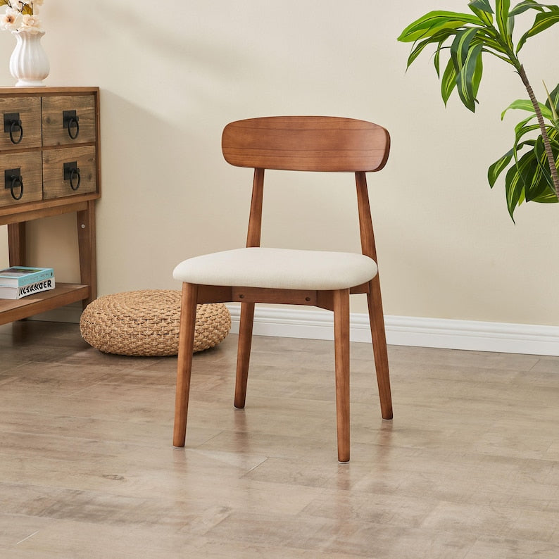 Modern Solid Wood Dining Chair in walnut with cream seat styled beside a wood cabinet and plant
