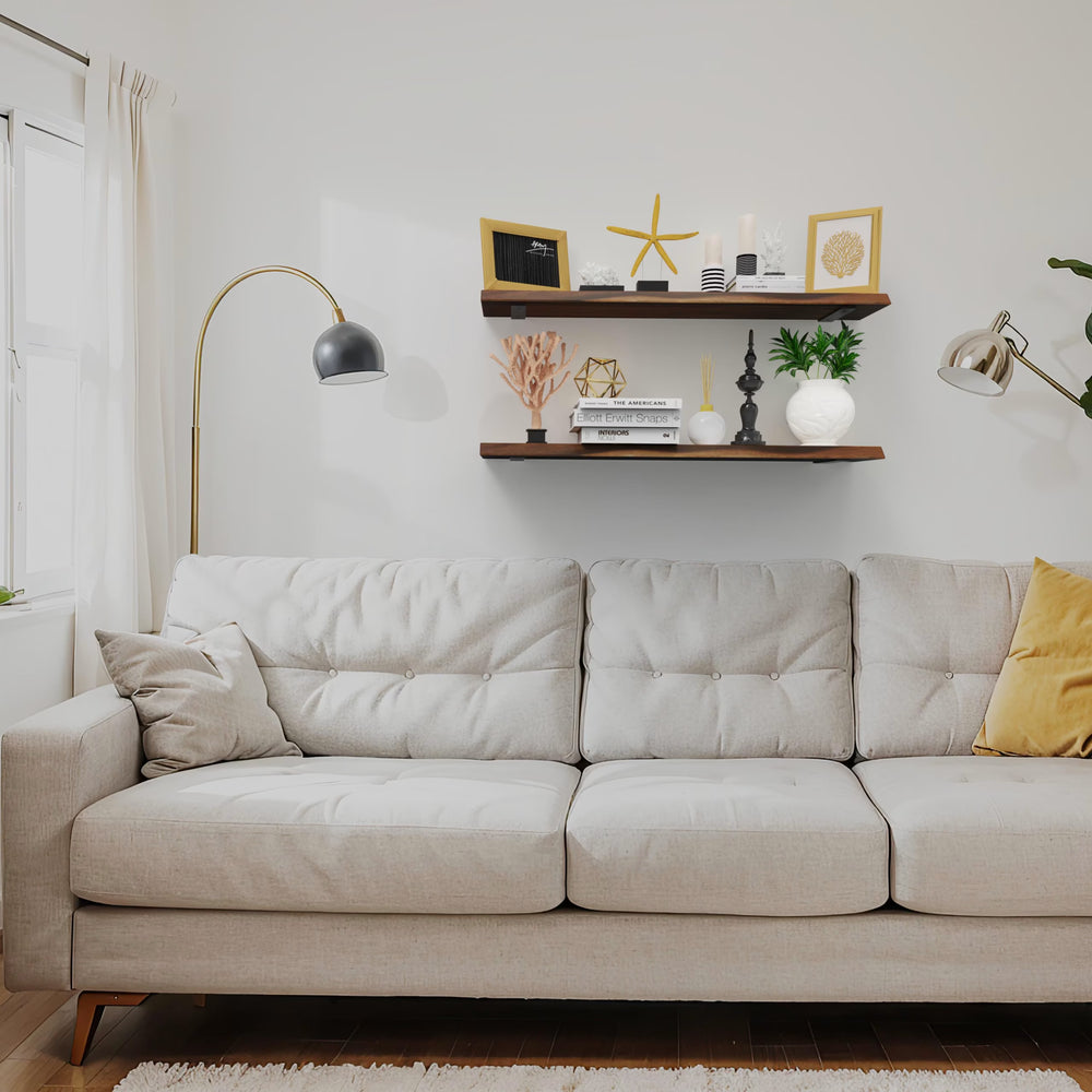 Two No Measure Floating Shelves in walnut with coastal decor above a beige sofa