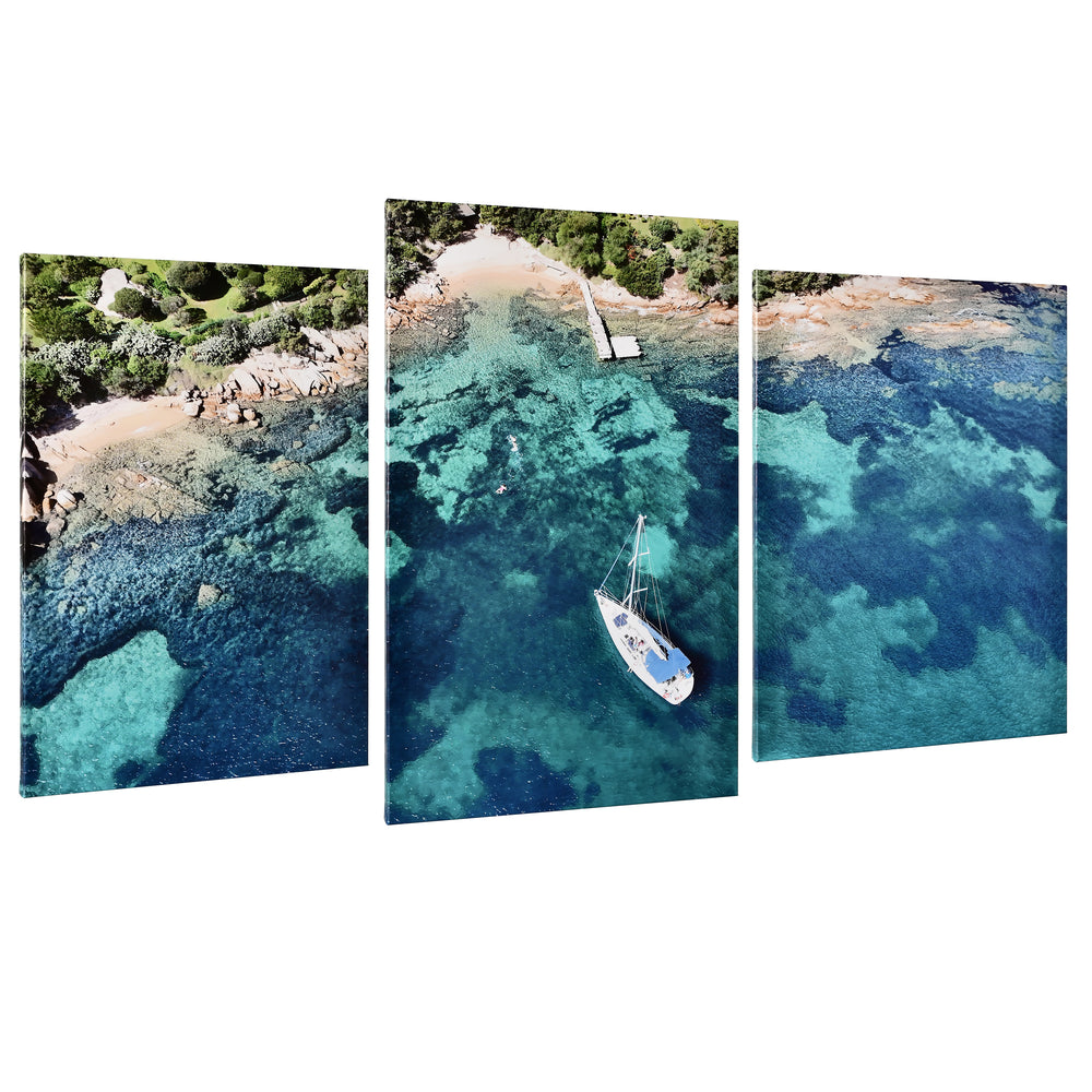 3-Panel Ocean canvas art angled floating view of a sailboat above blue and green water