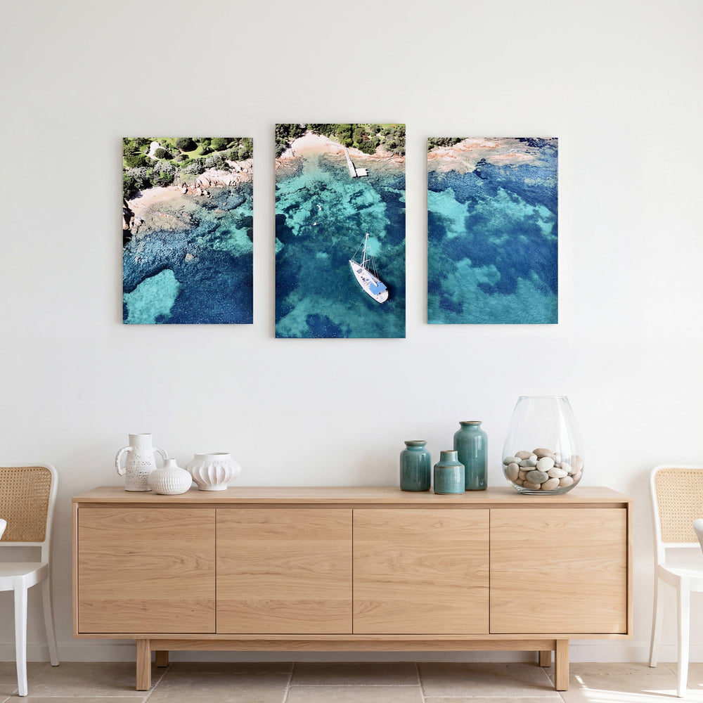 3-Panel Ocean canvas wall art above a light wood credenza with vases