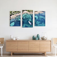 3-Panel Ocean canvas wall art above a light wood credenza with vases