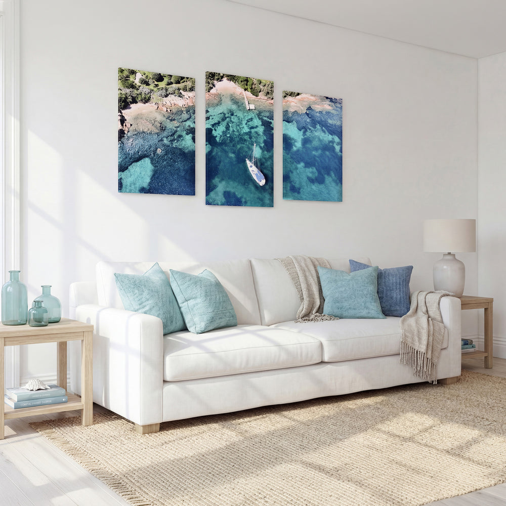 3-Panel Ocean canvas wall art above a white sofa in a sunlit living room