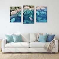 3-Panel Ocean canvas wall art above a white sofa with teal and blue pillows