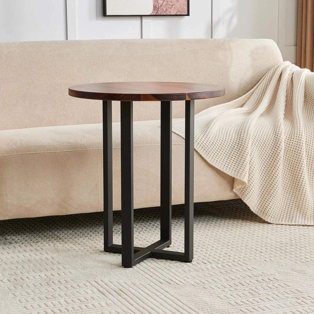 Round End Table in walnut with black metal base in front of a beige sofa