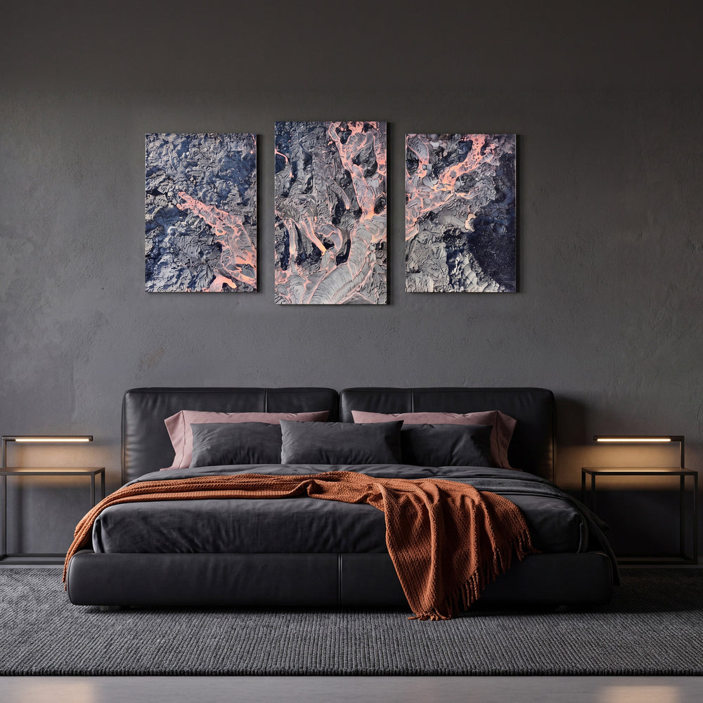 3-Panel Lava canvas wall art above a dark leather bed with a rust throw blanket
