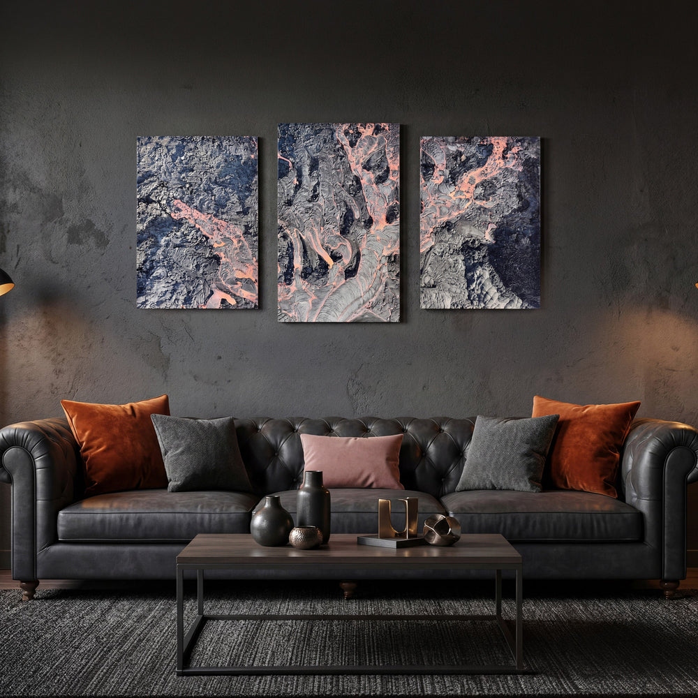 3-Panel Lava canvas wall art above a dark leather sofa with rust and gray pillows
