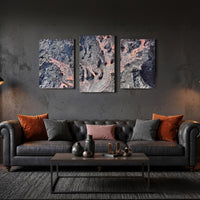 3-Panel Lava canvas wall art above a dark leather sofa with rust and gray pillows